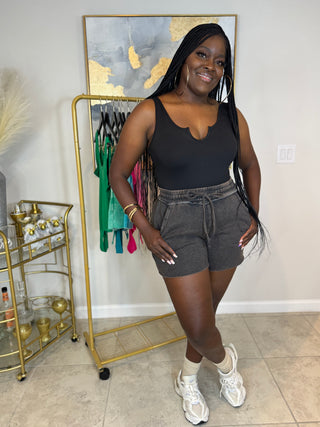 Black fleece drawstring shorts with pocket detail
Full outfit paired with casual sneakers and subtle glam