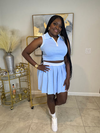 Two-piece baby blue tennis skirt set styled with sneakers