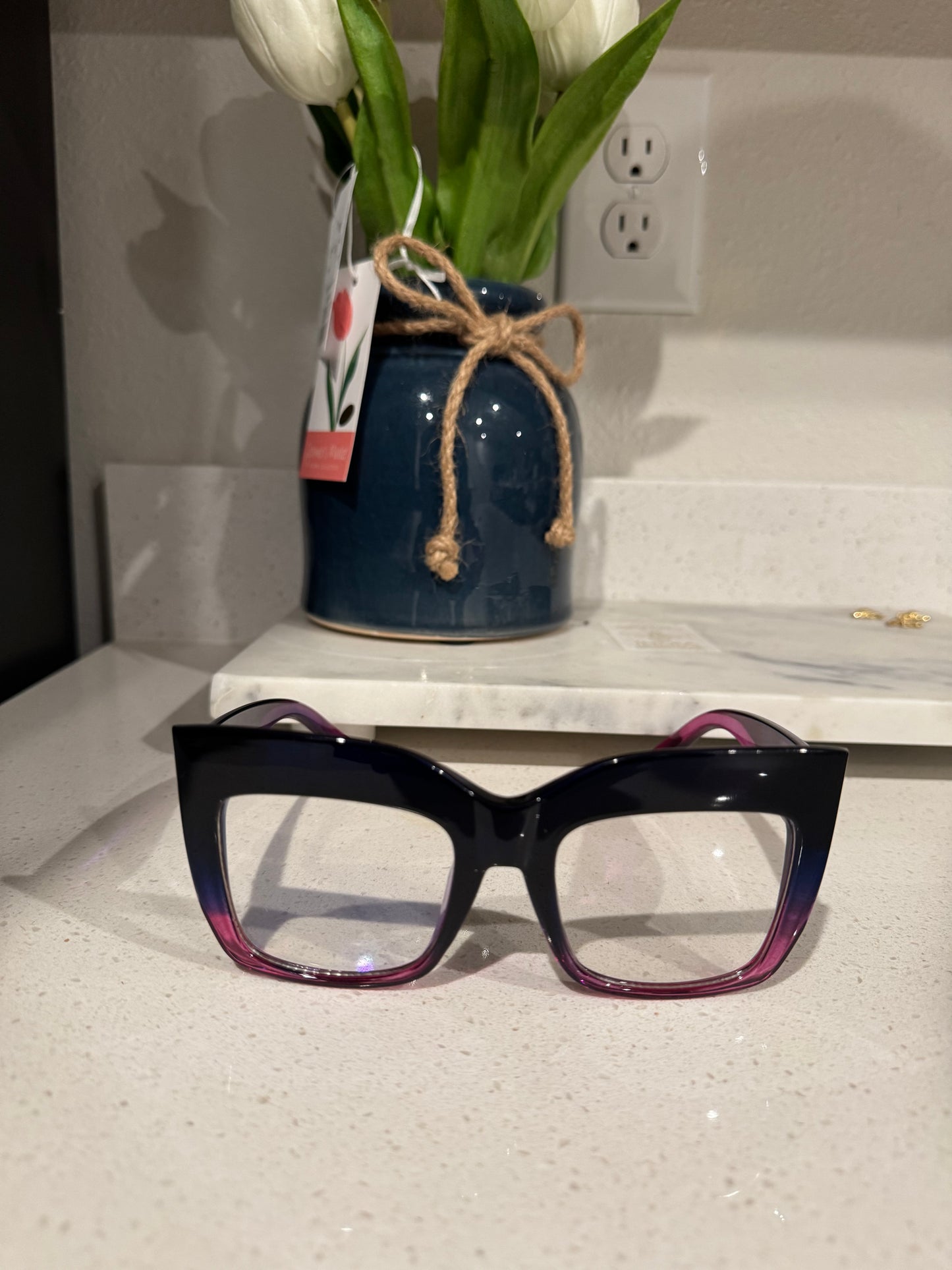 Bold gradient square cat-eye glasses with an oversized frame, transitioning from black to magenta. Stylish and trendy eyewear accessory for a statement look. Clear glasses. Clear sunglasses.